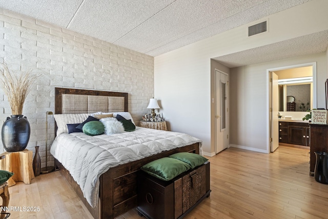 1200 Riverside Dr # 1232, Reno, NV 89503 - bedroom featuring light wood finished floors, a textured ceiling, and ensuite bath