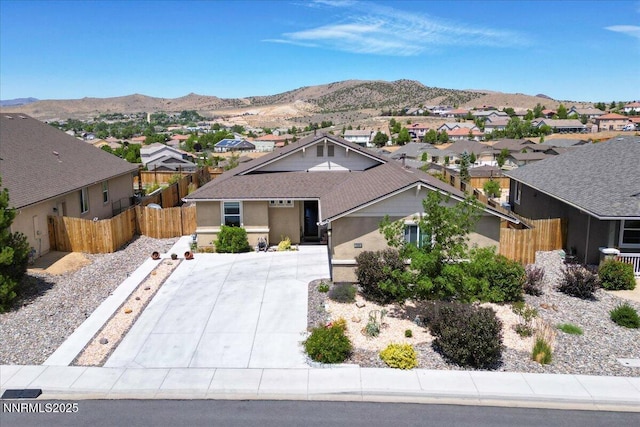 516 Beckwourth Dr, Reno, NV 89506 - view of front facade featuring a residential view, driveway, a mountain view, and stucco siding