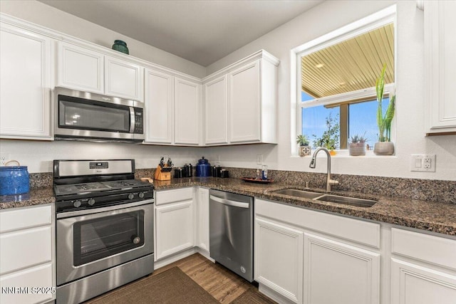516 Beckwourth Dr, Reno, NV 89506 - kitchen with stainless steel appliances, white cabinets, dark wood-type flooring, and dark stone countertops