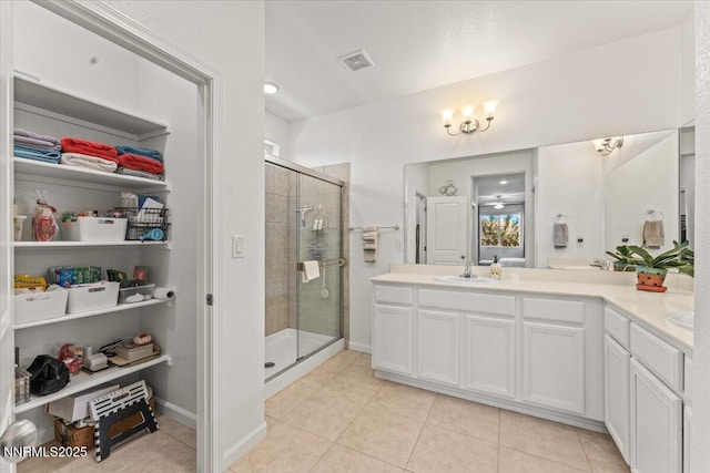 516 Beckwourth Dr, Reno, NV 89506 - bathroom featuring a stall shower, double vanity, and tile patterned flooring