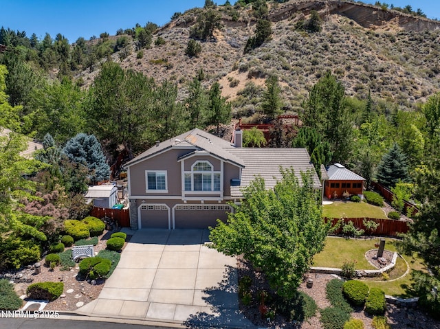 3280 Thornhill Dr, Reno, NV 89509 - view of front of home with an attached garage, driveway, and a mountain view