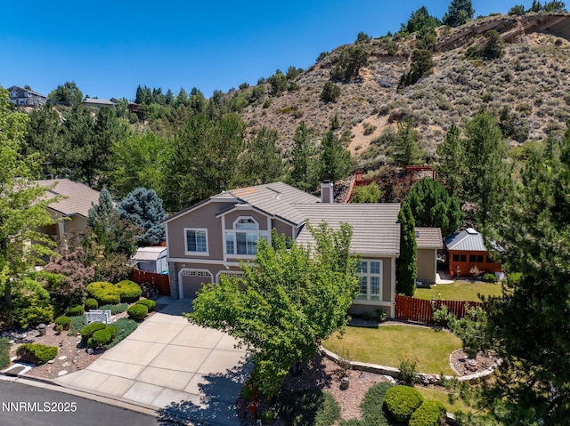 3280 Thornhill Dr, Reno, NV 89509 - view of front of home with an attached garage, a tiled roof, driveway, a chimney, and a mountain view