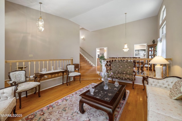 3280 Thornhill Dr, Reno, NV 89509 - living room featuring wood finished floors, stairs, and high vaulted ceiling