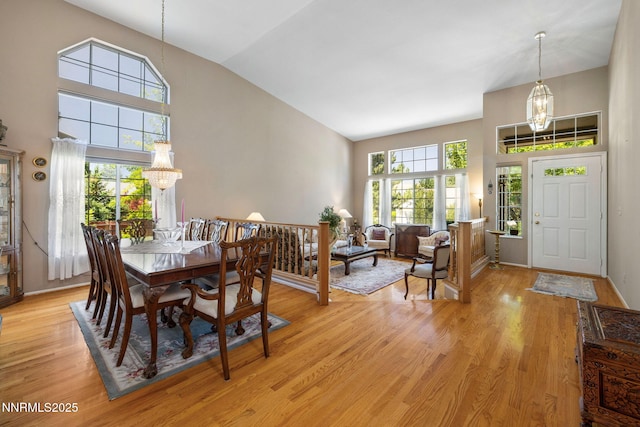 3280 Thornhill Dr, Reno, NV 89509 - dining room with a chandelier, high vaulted ceiling, and light wood finished floors