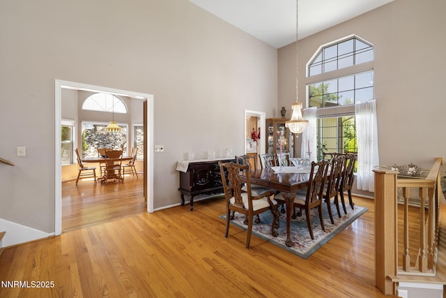 3280 Thornhill Dr, Reno, NV 89509 - dining area featuring a towering ceiling, light wood-style floors, and a chandelier