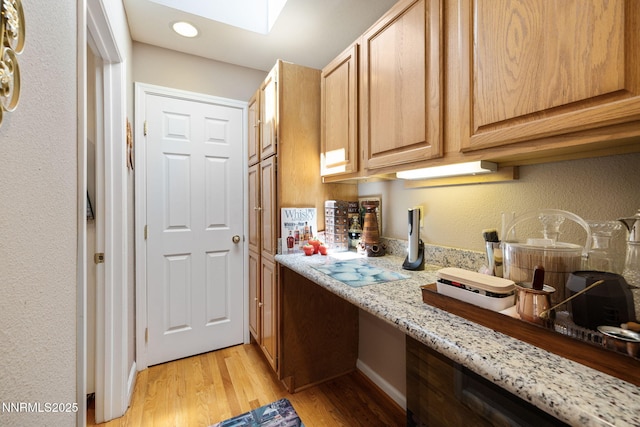 3280 Thornhill Dr, Reno, NV 89509 - kitchen featuring light stone counters, light wood-style floors, a skylight, recessed lighting, and light brown cabinetry