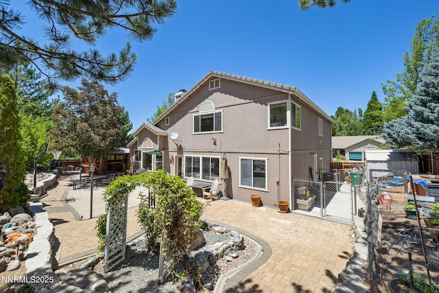 3280 Thornhill Dr, Reno, NV 89509 - rear view of property featuring a gate, a patio area, and a storage shed