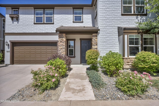 2125 Heavenly View Trl, Reno, NV 89523 - view of front of house featuring a garage, stone siding, and driveway