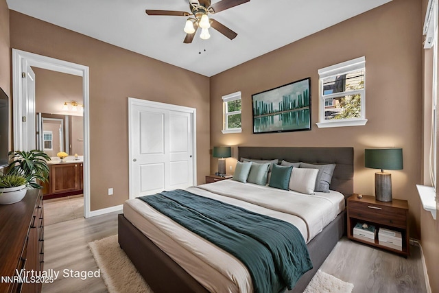 2125 Heavenly View Trl, Reno, NV 89523 - bedroom with multiple windows, light wood-style flooring, ensuite bathroom, and a ceiling fan