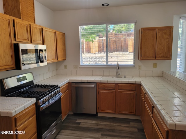 2967 Aspendale Dr, Reno, NV 89503 - kitchen with appliances with stainless steel finishes, healthy amount of natural light, and dark wood-style floors