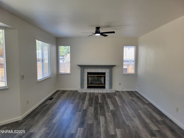 2967 Aspendale Dr, Reno, NV 89503 - unfurnished living room with a ceiling fan, dark wood-style flooring, and a tile fireplace