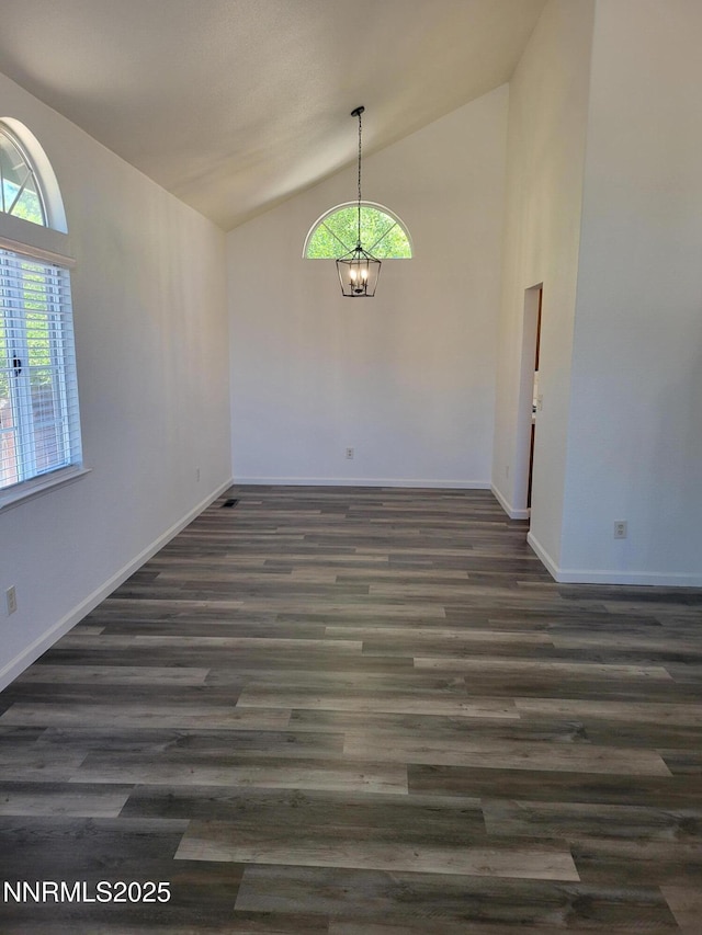 2967 Aspendale Dr, Reno, NV 89503 - unfurnished dining area featuring lofted ceiling, plenty of natural light, a chandelier, and dark wood-style flooring