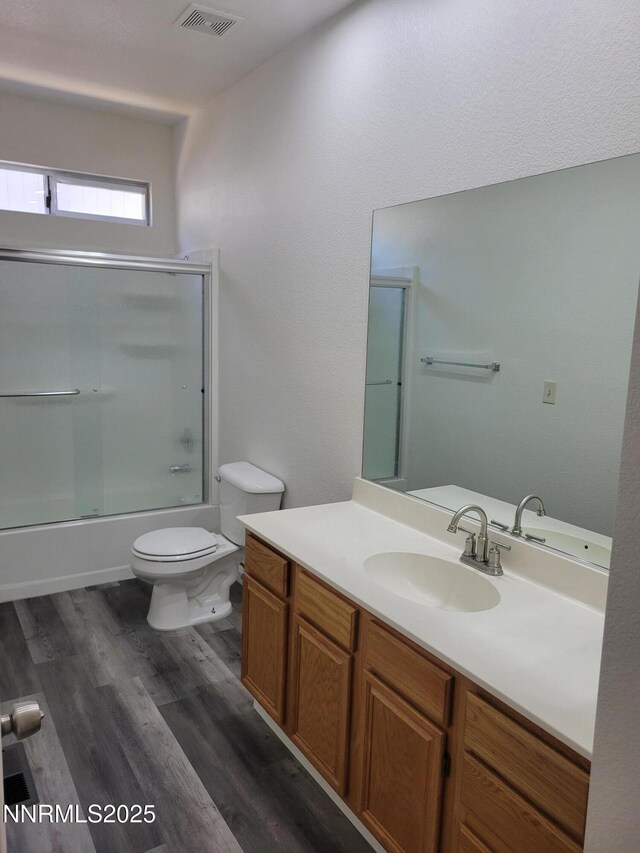 2967 Aspendale Dr, Reno, NV 89503 - full bath featuring vanity, shower / bath combination with glass door, and wood finished floors
