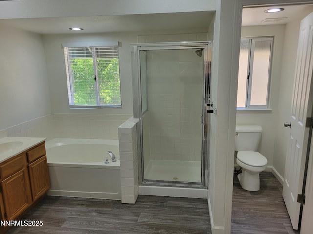 2967 Aspendale Dr, Reno, NV 89503 - bathroom featuring a bath, wood finished floors, a shower stall, vanity, and recessed lighting