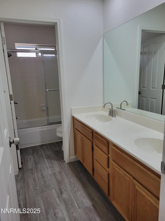 2967 Aspendale Dr, Reno, NV 89503 - bathroom with double vanity, wood finished floors, and shower / bath combination with glass door