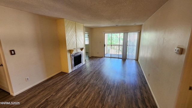 2300 Dickerson Rd Unit 16, Reno, NV 89503 - unfurnished living room featuring dark wood-type flooring, a textured ceiling, and a fireplace