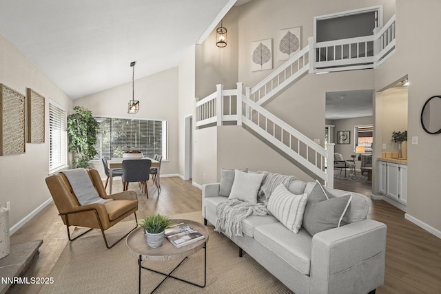 4030 Willowsprings Dr, Reno, NV 89519 - living area with wood finished floors, stairs, and high vaulted ceiling