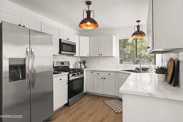 4030 Willowsprings Dr, Reno, NV 89519 - kitchen featuring stainless steel appliances, tasteful backsplash, white cabinetry, and light wood-style flooring