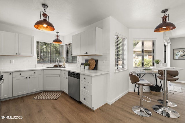 4030 Willowsprings Dr, Reno, NV 89519 - kitchen with stainless steel dishwasher, wood finished floors, and tasteful backsplash