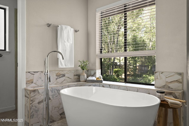 4030 Willowsprings Dr, Reno, NV 89519 - bathroom with a soaking tub, healthy amount of natural light, and tile walls