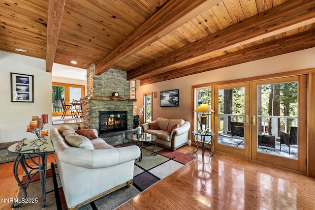 173 Hall Ct, Stateline, NV 89449 - living room featuring a stone fireplace, wood finished floors, a wooden ceiling with exposed beams, and healthy amount of natural light