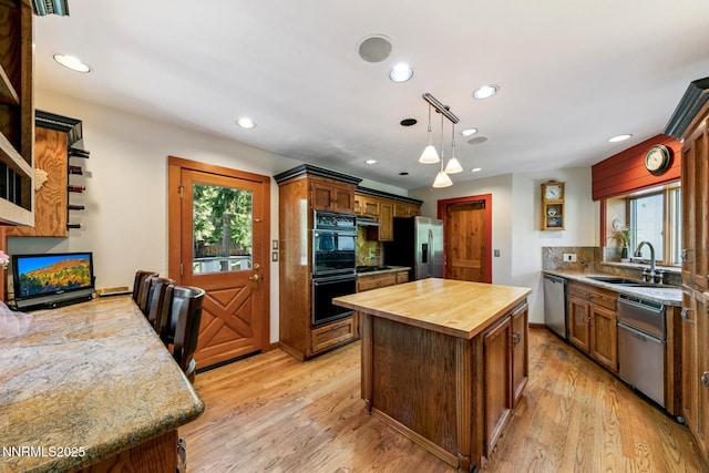 173 Hall Ct, Stateline, NV 89449 - kitchen featuring wood counters, stainless steel appliances, light wood-type flooring, recessed lighting, and a center island