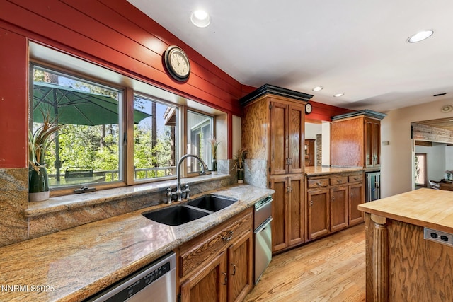 173 Hall Ct, Stateline, NV 89449 - kitchen featuring light wood-type flooring, brown cabinetry, recessed lighting, stainless steel dishwasher, and light stone countertops