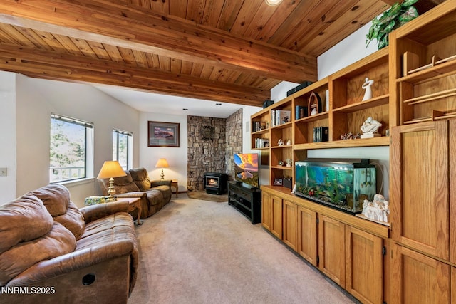 173 Hall Ct, Stateline, NV 89449 - living room featuring light colored carpet, a wood stove, and a wood ceiling with exposed beams