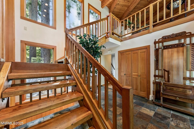 173 Hall Ct, Stateline, NV 89449 - stairs with a high ceiling, a wooden ceiling with exposed beams, and stone tile flooring