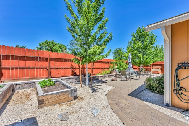6670 Lotus St, Reno, NV 89506 - fenced backyard with a patio area, a garden, and outdoor dining space