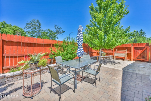 6670 Lotus St, Reno, NV 89506 - fenced backyard with a patio area, outdoor dining space, and a gate