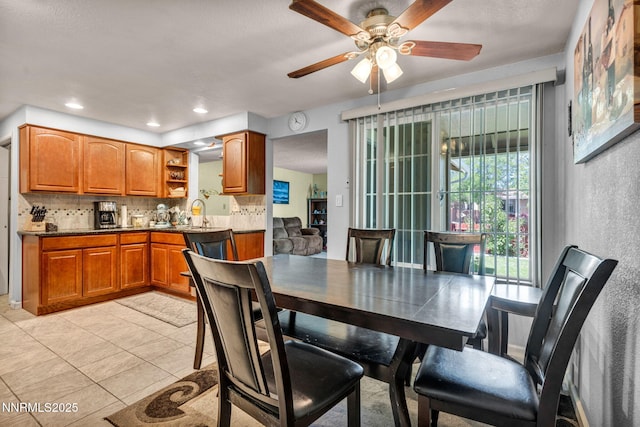 6670 Lotus St, Reno, NV 89506 - dining space with a ceiling fan and light tile patterned flooring