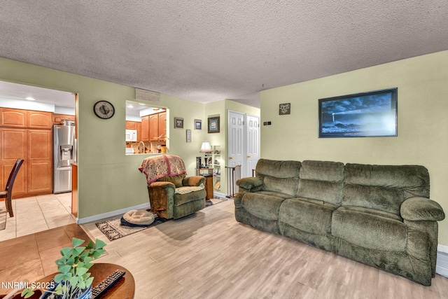 6670 Lotus St, Reno, NV 89506 - living area featuring light wood-style flooring and a textured ceiling