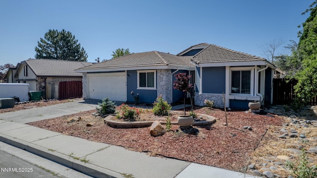 777 W Bonanza Dr, Carson City, NV 89706 - single story home featuring stone siding, a tiled roof, an attached garage, and driveway