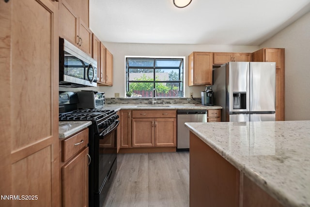 777 W Bonanza Dr, Carson City, NV 89706 - kitchen with stainless steel appliances, light wood-style flooring, light stone counters, and brown cabinets