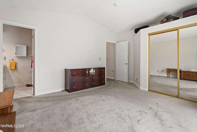 777 W Bonanza Dr, Carson City, NV 89706 - unfurnished bedroom with lofted ceiling, carpet, a closet, and ensuite bath