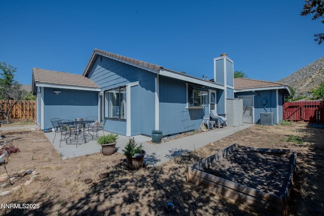 777 W Bonanza Dr, Carson City, NV 89706 - rear view of property featuring a patio and a chimney