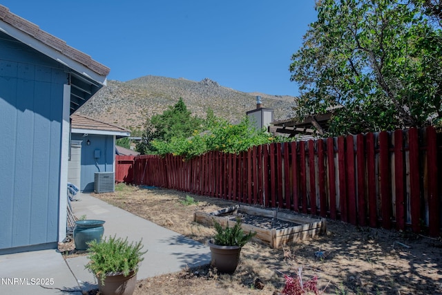 777 W Bonanza Dr, Carson City, NV 89706 - fenced backyard with a mountain view and a vegetable garden