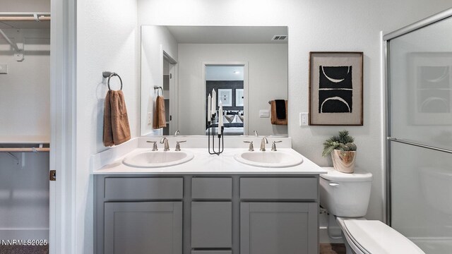 1639 Prancer St Lot # 47, Reno, NV 89523 - bathroom featuring a walk in closet, double vanity, and a shower