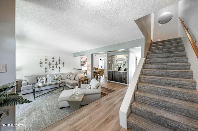 1419 Foster Dr, Reno, NV 89509 - living area featuring wood finished floors, stairway, and a textured ceiling