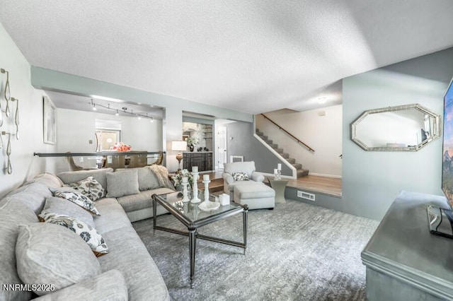 1419 Foster Dr, Reno, NV 89509 - carpeted living area featuring stairway, track lighting, and a textured ceiling