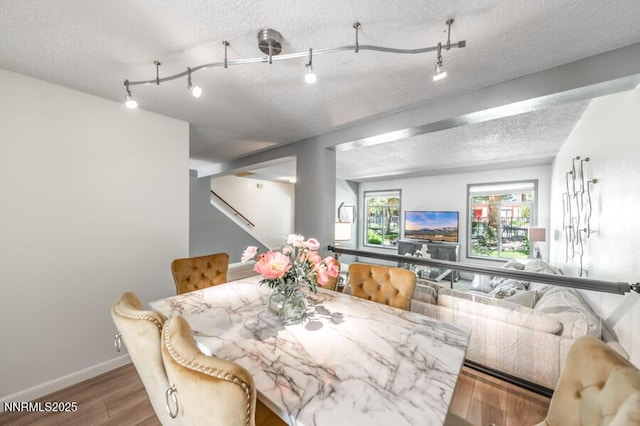 1419 Foster Dr, Reno, NV 89509 - dining space featuring a textured ceiling, wood finished floors, and stairs