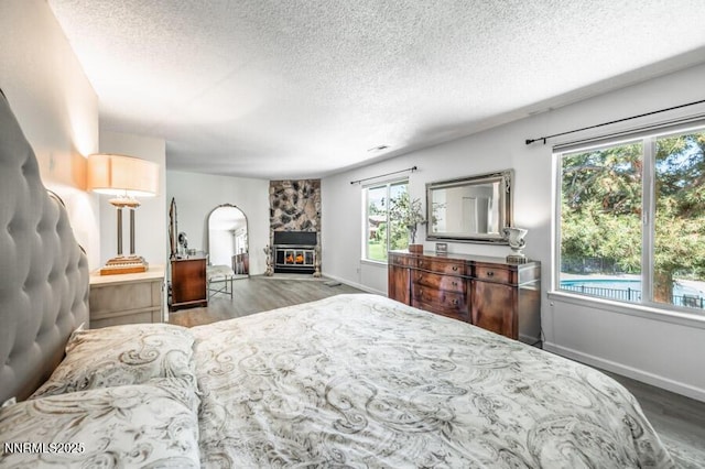 1419 Foster Dr, Reno, NV 89509 - bedroom featuring wood finished floors, a textured ceiling, multiple windows, and arched walkways