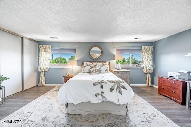 1419 Foster Dr, Reno, NV 89509 - bedroom with wood finished floors, a textured ceiling, and a closet