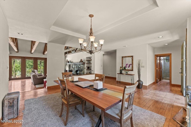 6195 Philoree Ln, Reno, NV 89511 - dining space with a chandelier, light wood-style flooring, recessed lighting, and a tray ceiling