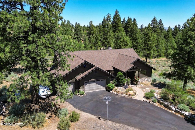 6195 Philoree Ln, Reno, NV 89511 - view of front of home featuring a garage, driveway, and a wooded view