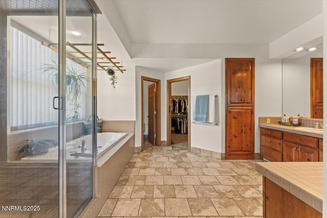 6195 Philoree Ln, Reno, NV 89511 - bathroom with vanity, a garden tub, a walk in closet, a stall shower, and recessed lighting