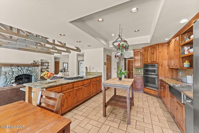 6195 Philoree Ln, Reno, NV 89511 - kitchen featuring stainless steel appliances, open floor plan, recessed lighting, brick patterned floors, and a tray ceiling