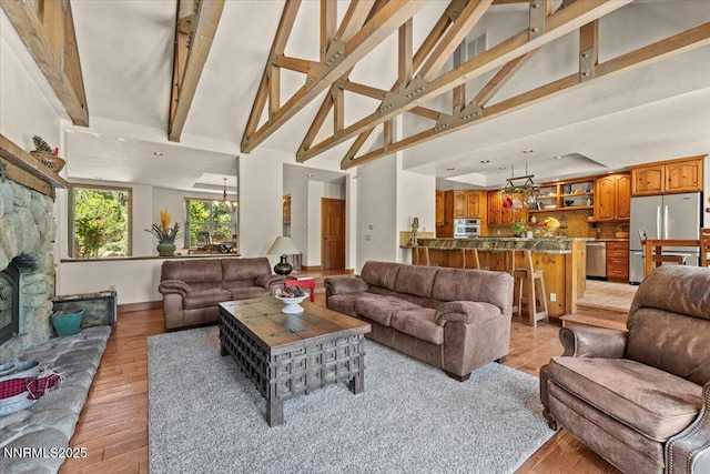 6195 Philoree Ln, Reno, NV 89511 - living room featuring high vaulted ceiling, beam ceiling, and light wood-style floors