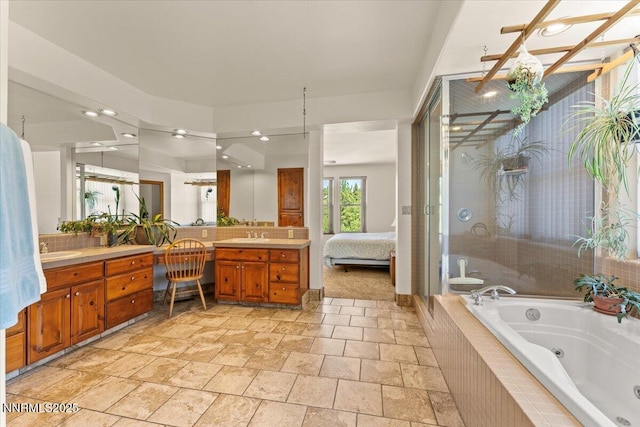 6195 Philoree Ln, Reno, NV 89511 - bathroom featuring a tub with jets, vanity, a stall shower, stone finish flooring, and ensuite bathroom